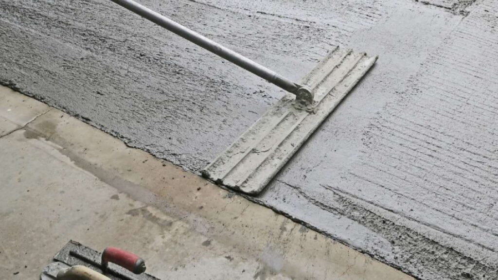 Freshly poured concrete being smoothed with a trowel, showcasing a driveway under construction in Wicklow